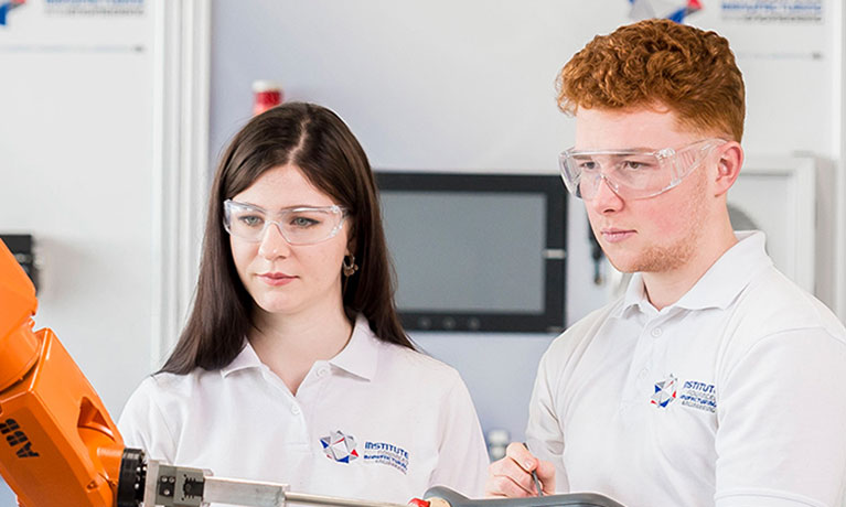 Two students looking at machinery