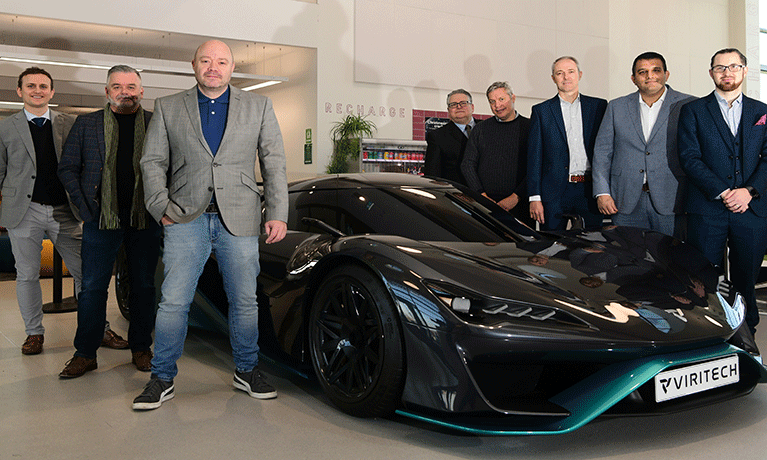 Business leaders stood around a car in the Mira Technology Institute