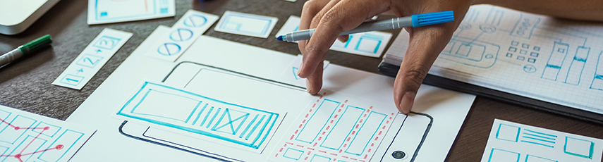 Person drawing a diagram of a phone on paper