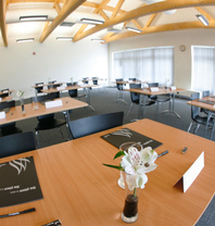 The Westwood Suite set up with tables and chairs for a conference event