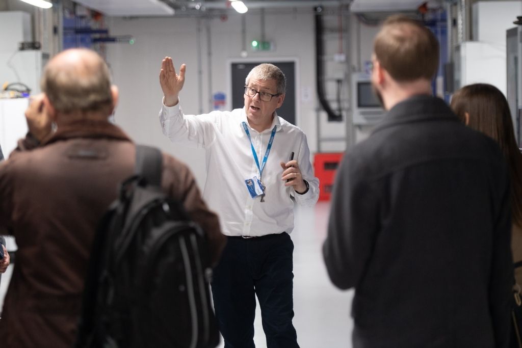man showing people around facilities at C-ALPS