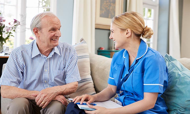 Nurse caring for elderly gentleman