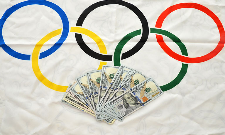 The 2020 Olympic games flag with a pile of money