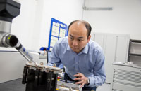 Lecturer using a piece of equipment in a sicence lab