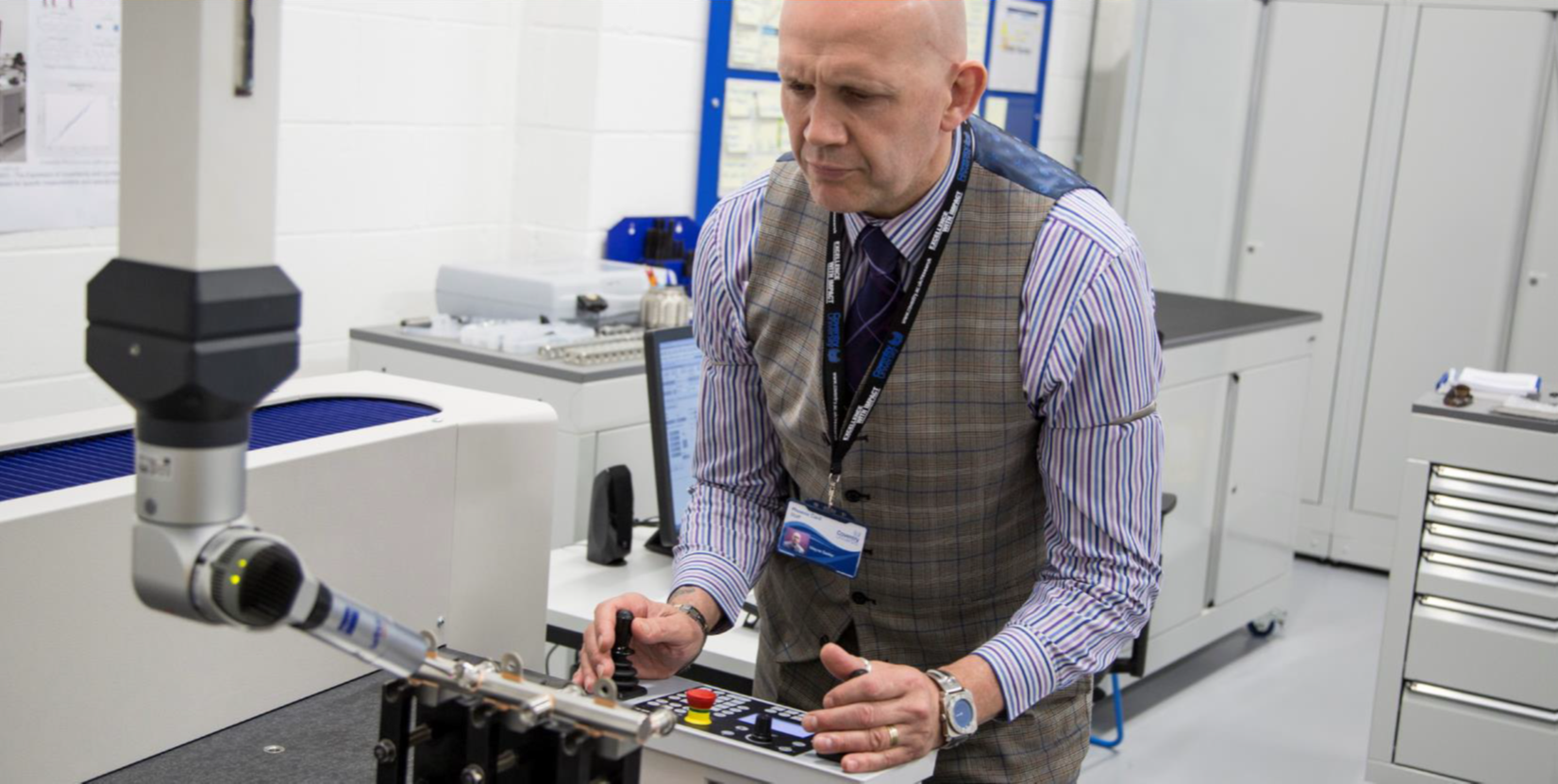 Lecturer using a piece of equipment in a lab