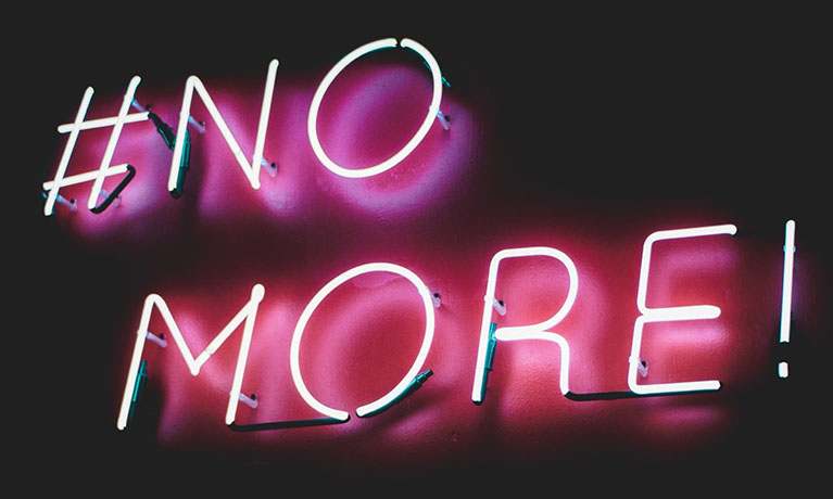 Illuminated sign saying no more.