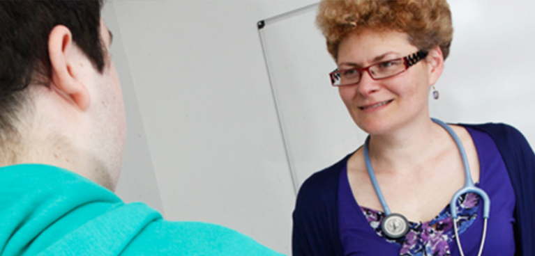female doctor smiling at another person