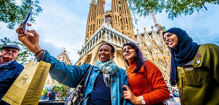 a group of women taking a photo in front of a historic building
