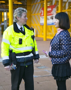 Woman outside speaking to a security guard
