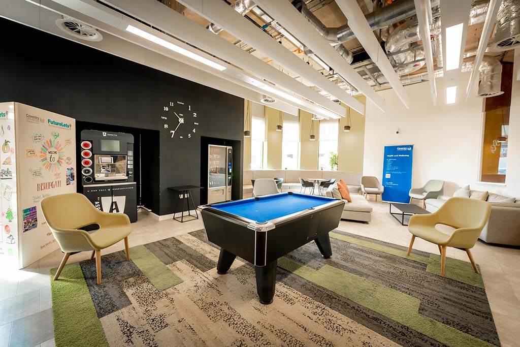 Pool table and chairs in an open plan space
