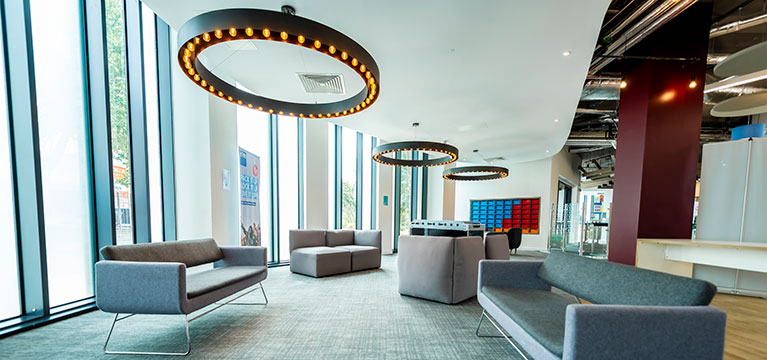 Open plan reception area with sofas and bean bags 