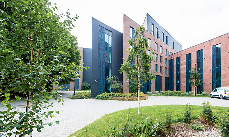 Outside view of an accommodation block with trees