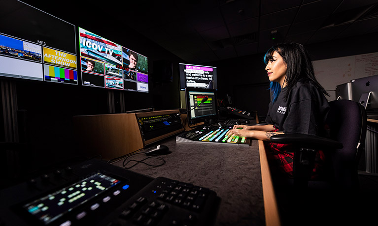 Student using a large AV desk.