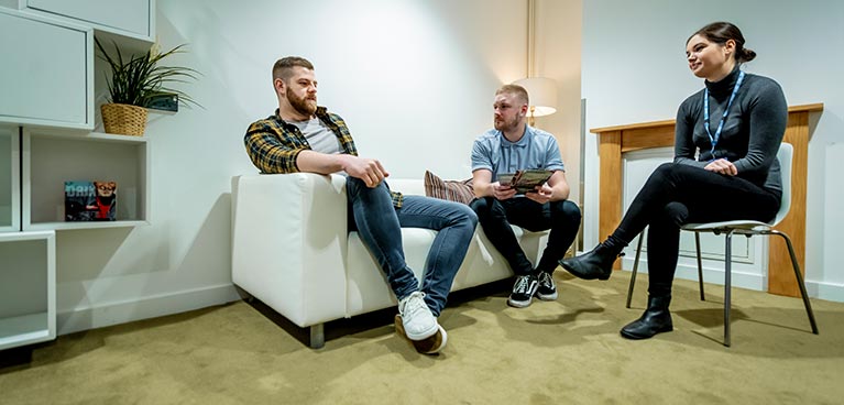 People sat on chairs in a consultation room