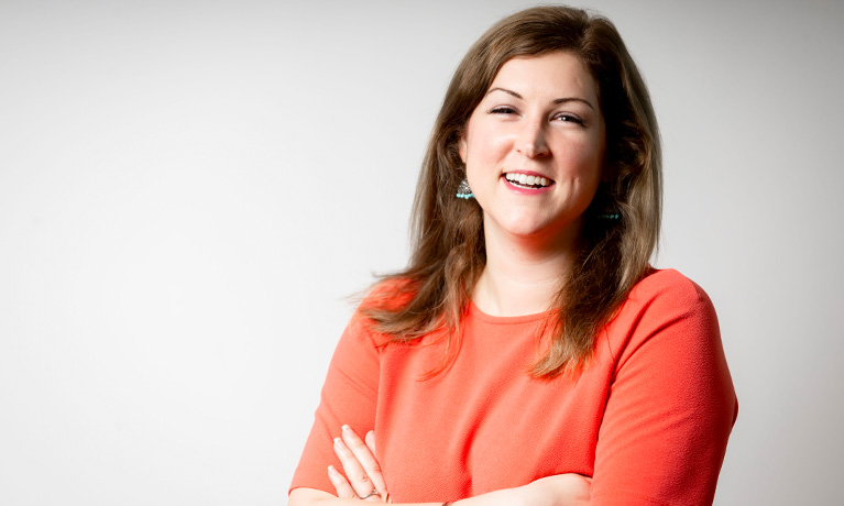 Kim Bul smiling with her arms crossed