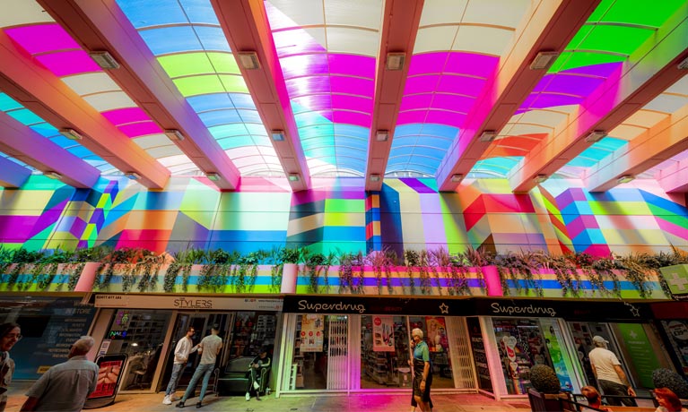 An internal view of one of Coventry city centre's shopping malls, brightly painted by artist Morag  Myerscough.