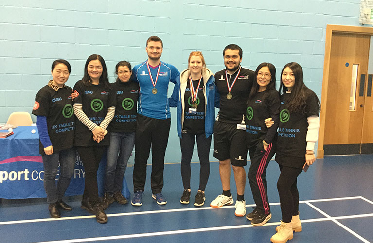 team group photo inside a sports hall