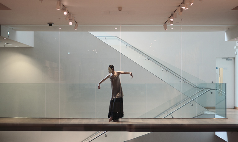 Lady with a mask on standing on the stairs