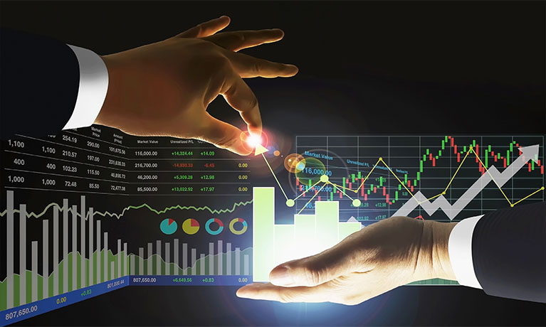 Two hands in front of a page of graphs, the left hand looks like it is pinching a bit of the graph and the right hand is catching it