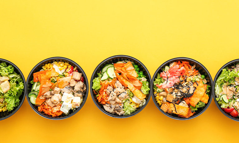 Five bowls of healthy food on a yellow background