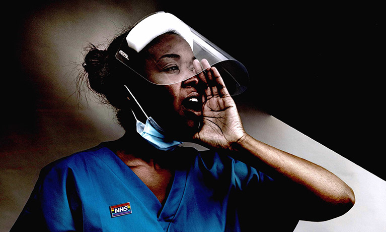 A nurse wearing Personal Protective Equipment shouts