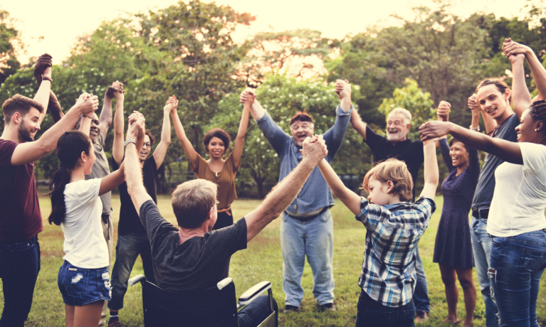 Group of people holding hand together in the park