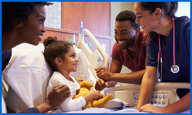 Young girl on a hospital bed with parents and nurse around her bedside.