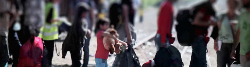 Group of people wearing thick clothing and carrying heavy luggage walking on the streets