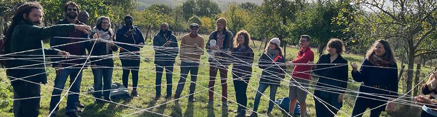 Group of people working with a string spider web