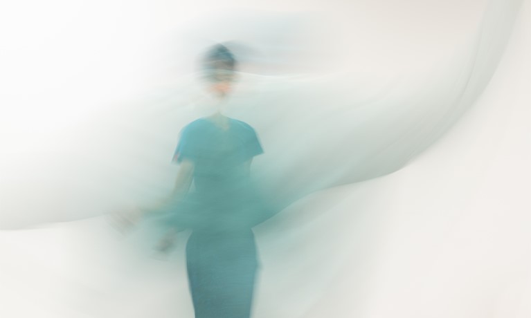 Blurred image of a person wearing a blue dress. Image credit: Christian Kipp.