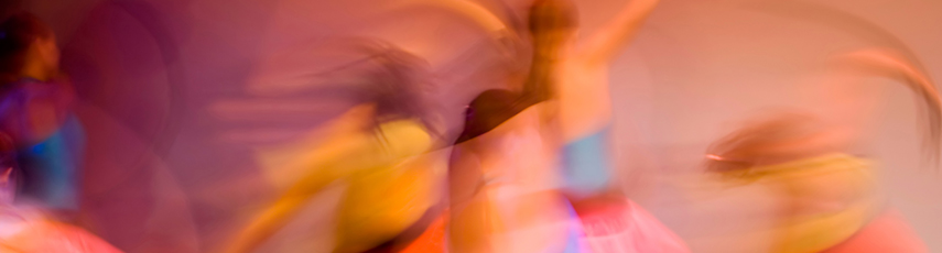 Motion blur of dancers in colourful costumes