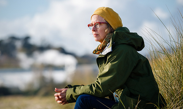 Rosemary Lee looking out across a wild landscape.