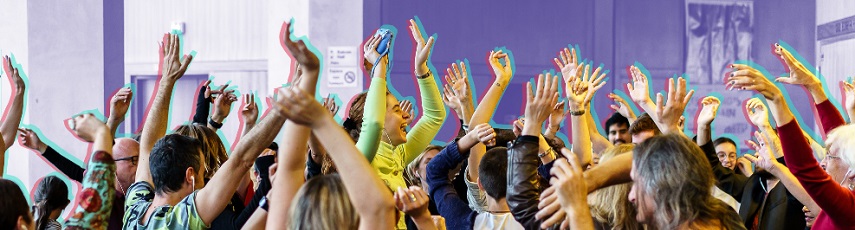 Group of people raising hands in air during music performance.