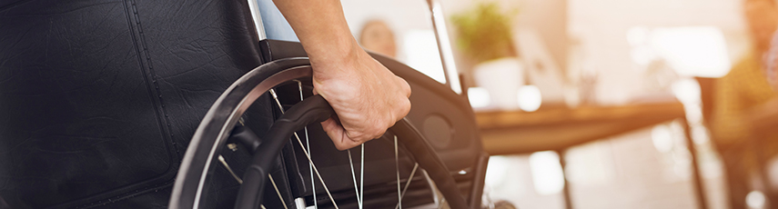 Man sitting in wheelchair with his hand on the wheel