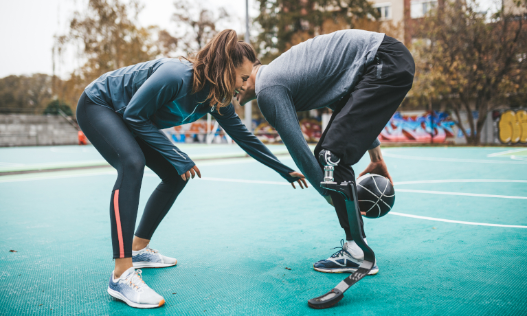 Female and male with a prosthetic leg playing sports