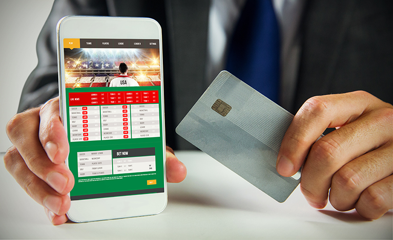 Businessman using a sports gambling app on a smartphone