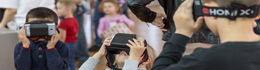 Three children using virtual reality head-sets