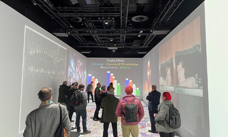 People watching an exhibition inside a gallery