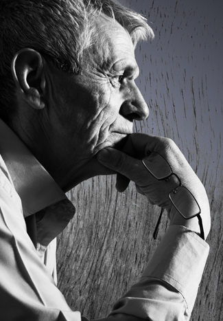 An older man resting his chin on his hand.