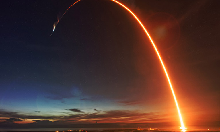 Rocket launch in the night sky.