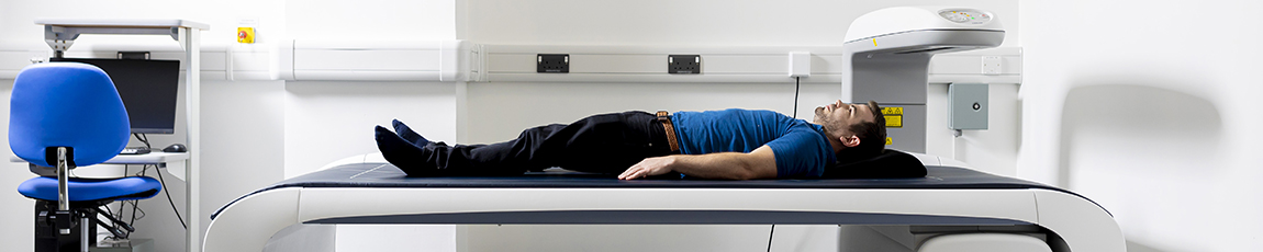 Man lying on an MRI bed waiting for a scan
