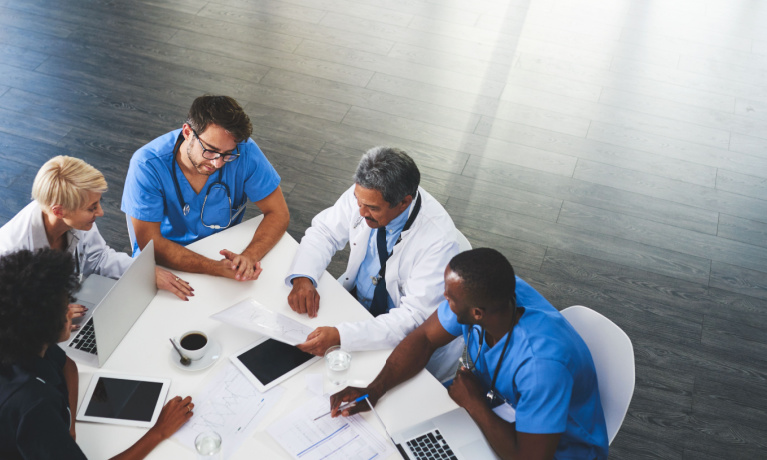 Healthcare workers gathered round a table