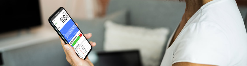 A woman looks at a health report on her phone