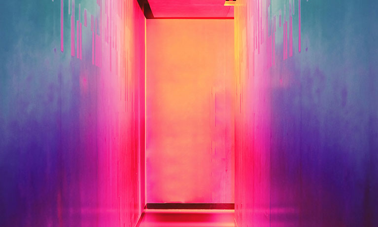 a room lit by pink and yellow neon lights