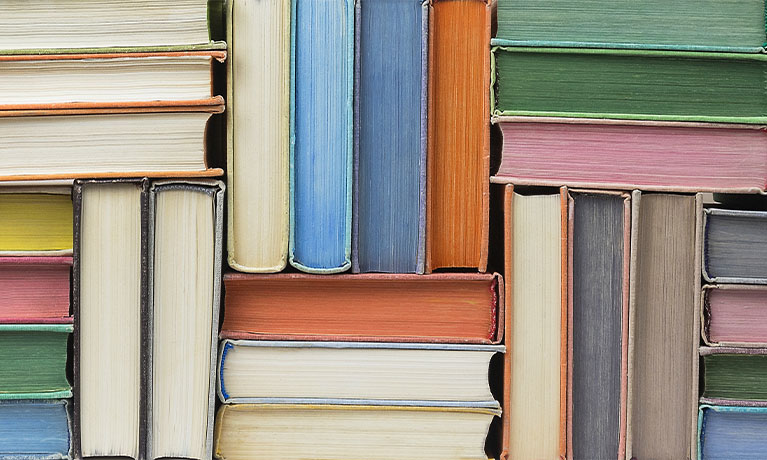 Coloured books stacked up