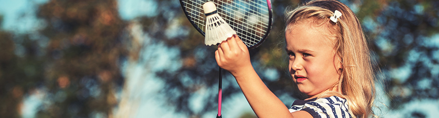 Young girl playing badminton