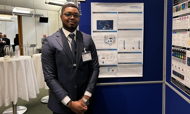 Abiola Babatunde at conference presenting research on poster