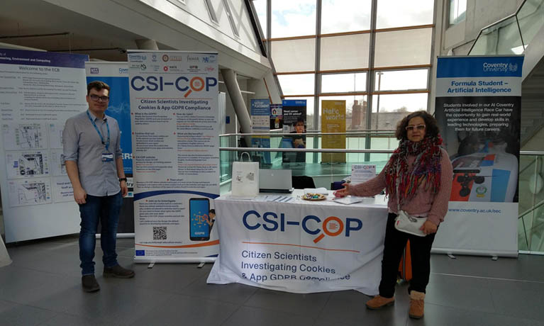 Huma Shah and Jaimz Winter in the Engineering Building presenting CSI-COP banners