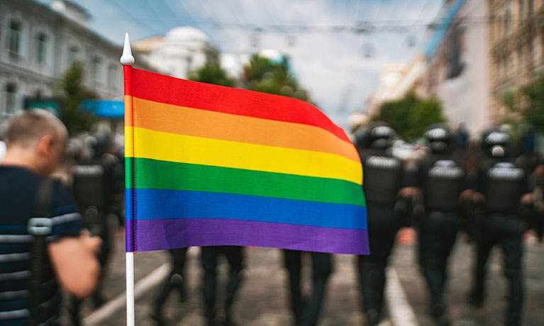 Rainbow flag in front of a group of people