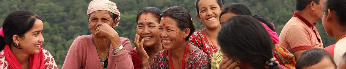 A group of Asian women sitting in a circle, smiling and talking
